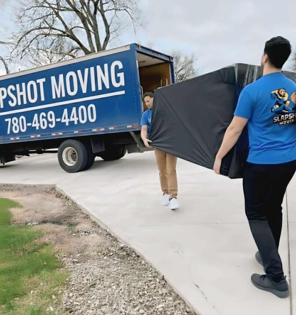 Reliable moving services by Slapshot Moving, professional team loading or unloading boxes.